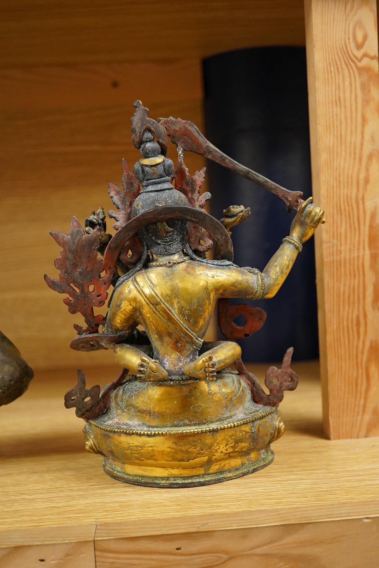 A Sino Tibetan gilt bronze group of Mahakala and consort, 22cm high